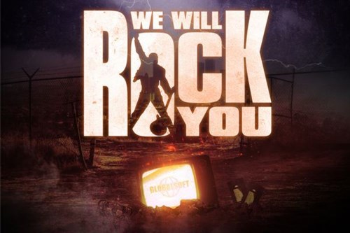 Promotional artwork for We Will Rock You. The title appears in bold, distressed block letters, with the silhouette of a performer holding a guitar raised high in the centre of the word ‘Rock’. Behind is a stormy sky and barbed-wire fence. At the bottom, a glowing television screen displays the word ‘Globalsoft’ alongside scattered objects including a broken crown and cassette tapes.