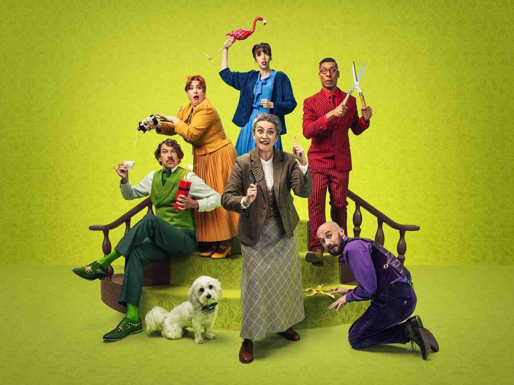 Promotional image for Murder, She Didn’t Write: The Improvised Murder Mystery, featuring six colourful characters and a small white dog posed dramatically on green stairs against a bright green patterned background.