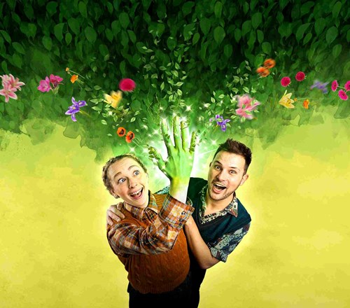 A person holds their hand into the air. Their hand is all green and from their fingers flowers and leaves are sprouting. Another person stands behind them staring at the hand. There are different flowers above their heads. 