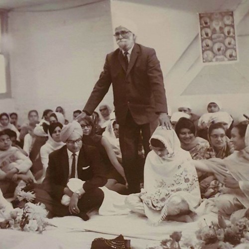A photograph of a bridegroom’s father offering blessings as the traditions of a Punjabi Sikh wedding are brought to Yorkshire.