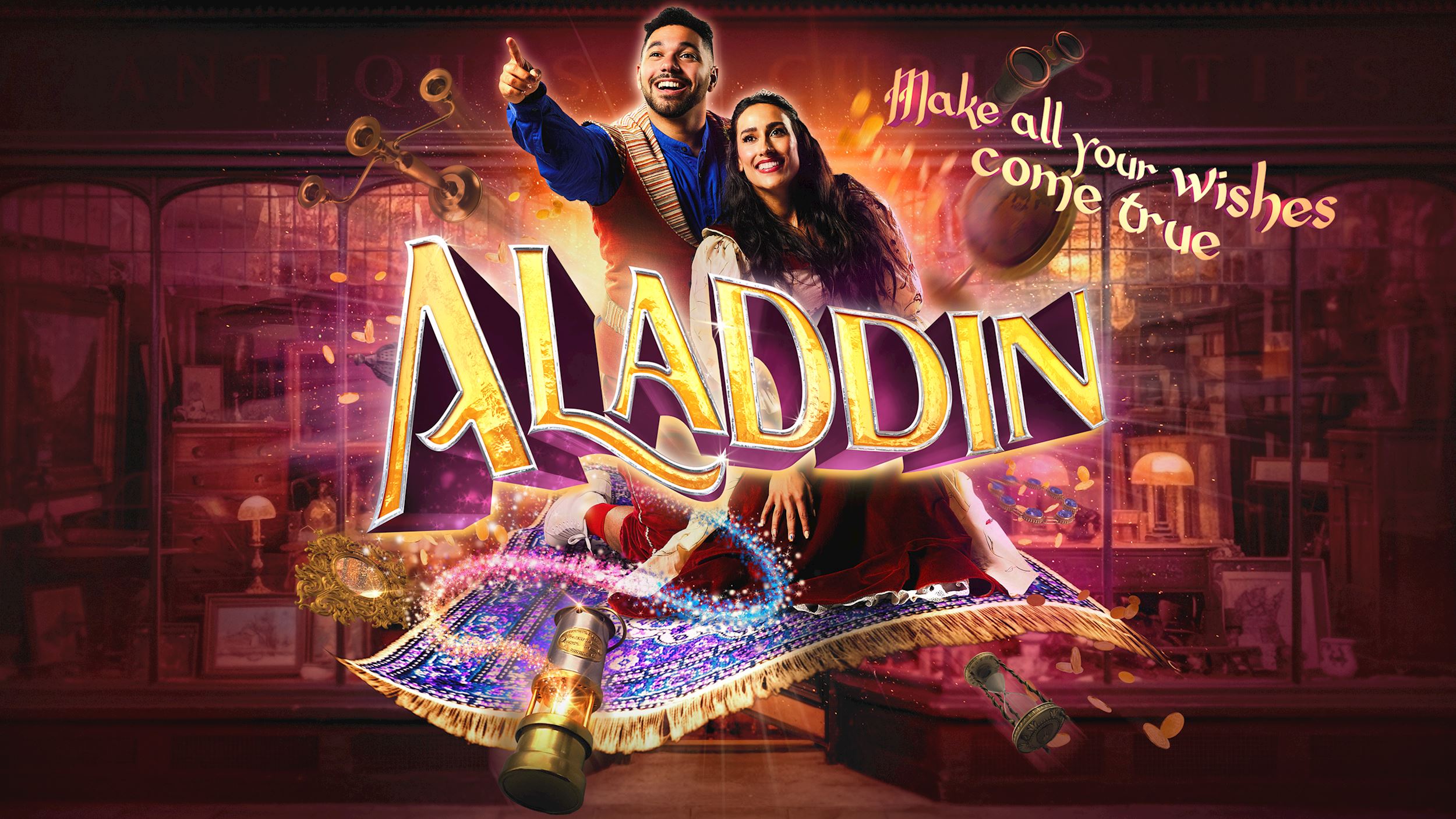 Promotional poster for Aladdin showing two performers on a flying magic carpet surrounded by magical effects and treasures, with the title "Aladdin" and the tagline "Make all your wishes come true."