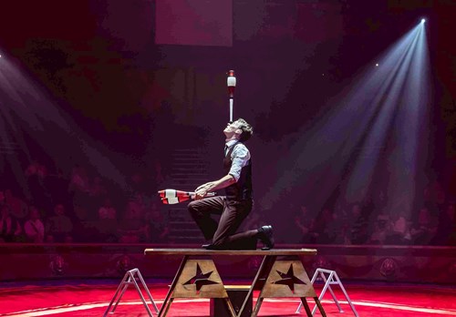 Michael Jordan, performer from High Jinx, balances a juggling pin on his nose.