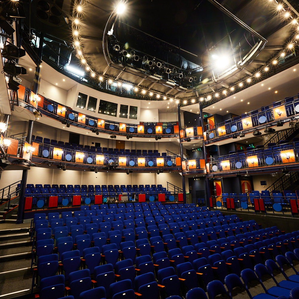 View of the Lawrence Batley Theatre auditorium, a modern space with 14 rows of 18 seats downstairs, and 2 balconies with seats on the sides and forward facing