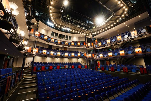 View of the Lawrence Batley Theatre auditorium, a modern space with 14 rows of 18 seats downstairs, and 2 balconies with seats on the sides and forward facing