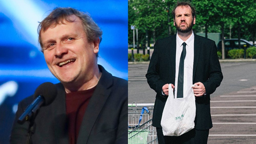 Split-screen promotional image featuring two comedians. On the left, a smiling performer speaks into a microphone on stage against a blue-lit background. On the right, a bearded performer in a black suit and tie stands in a supermarket car park holding a plastic shopping bag, with trees and parked cars in the background.