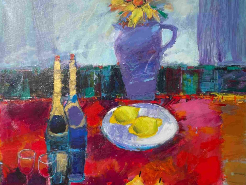 A vibrant still life painting featuring a purple vase with yellow and orange flowers, a red tablecloth, two wine bottles, two filled glasses, a plate with two lemons, and two pears. The background includes cool blue and purple tones with a window or curtain.